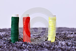 Colorful thread spools are used in fabric and textile industry. Multicolor sewing threads. Blurry, selective focus