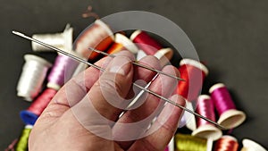colorful thread wound bobbins, large needle and small sewing needle, classic manual sewing needle