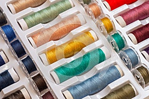Colorful threads and plastic bobbins for sewing machines