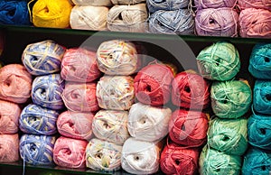 Colorful threads. Selection of colorful yarn wool on shopfront. Knitting background, a lot of balls. Knitting yarn for