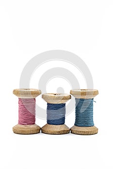 Colorful threads for sewing. Different threads on wooden vintage reels