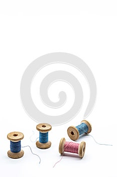 Colorful threads for sewing. Different threads on wooden vintage reels