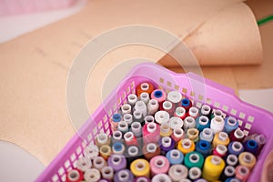 Colorful threads on a shelf at a sewing workshop, close-up