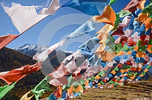 Colorful tibetan flags and snow mountain at Siguniang scenic area,chengdu, China