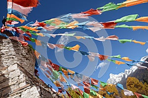 Colorful tibetan flags and snow mountain at Siguniang scenic area , China