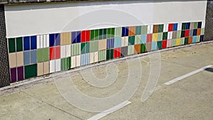 Colorful tile of sidewall along a road