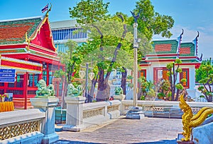 The colorful tiled roofs and golden Naga serpents of Wat Bowonniwet Vihara in Bangkok, Thailand