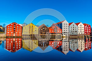 Colorful timber houses surrounding river Nidelva in the Brygge district of Trondheim, Norway