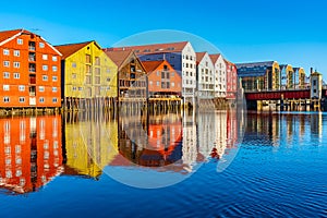 Colorful timber houses surrounding river Nidelva in the Brygge district of Trondheim, Norway