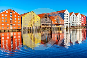 Colorful timber houses surrounding river Nidelva in the Brygge district of Trondheim, Norway