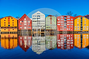 Colorful timber houses surrounding river Nidelva in the Brygge district of Trondheim, Norway