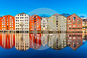 Colorful timber houses surrounding river Nidelva in the Brygge district of Trondheim, Norway