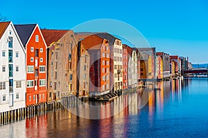 Colorful timber houses surrounding river Nidelva in the Brygge district of Trondheim, Norway