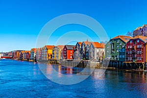 Colorful timber houses surrounding river Nidelva in the Brygge district of Trondheim, Norway