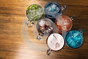 Colorful toned cocktails on wooden background. Frutal alcoholic cocktails. Colorful drinks concept