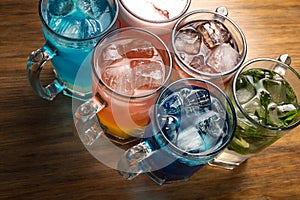 Colorful toned cocktails on wooden background. Frutal alcoholic cocktails. Colorful drinks concept