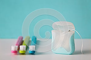 Colorful toothbrushes and dental floss.