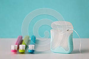Colorful toothbrushes and dental floss. photo