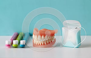 Colorful toothbrushes, dentures and dental floss.