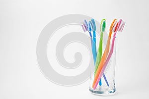 Colorful toothbrushes in glass photo