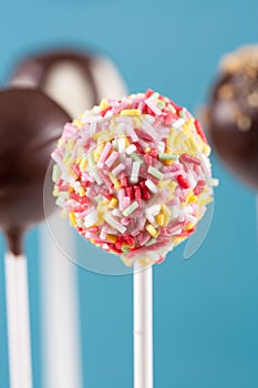 Colorful topping cake pop on blue background