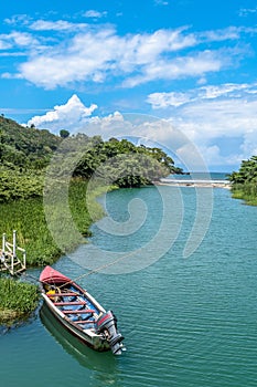 Colorful Tour Boat/Fishing Boat in scenic tropical landscape