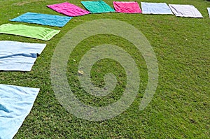 Colorful towels on the grass for a Yoga class