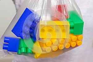 Colorful toy bricks, blocks for constructing and building in a plastic bag, package
