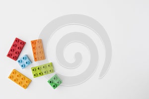 Colorful toy bricks on white background