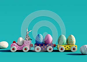 Colorful toy train with bunny and Easter eggs on turquoise blue background