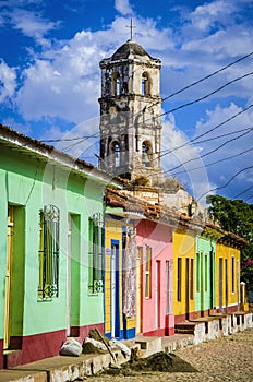 Colorful traditional houses and old church tower in the colonial town of Trinidad, Cuba