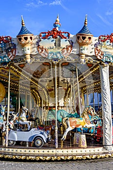 Colorful traditional old french caroussel in city park in sunny day