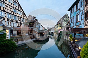 Colorful traditional old french houses on the side of canal Lauch at the evening in Petite Venise, Colmar, ribeauville, France.