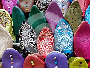 Colorful traditional slippers or shoes at a Moroccan bazaar in Marrakech.