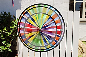 A colorful triple wheel wind spinner