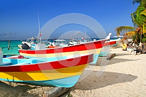 Colorful tropical boats in sand Isla Mujeres photo