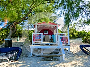 Colorful tropical cabanas or shelters on the beach of Half Moon Cay
