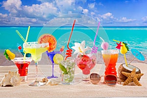 Colorful tropical cocktails at beach on white sand