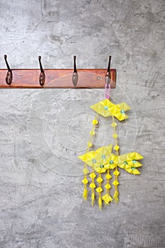 Colorful of tropical fish mobile hanging on cement background , Thai-style fish mobiles Pla ta pain photo