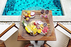 Colorful tropical fruit plate by the pool