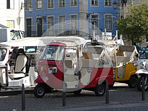 Colorful tuk tuks parked in downtown Lisbon, Portugal, Europe