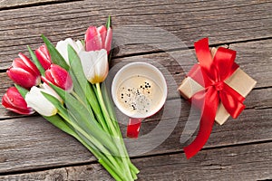 Colorful tulips, gift box and red coffee cup
