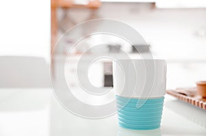 Colorful turquoise cup on a kitchen counter