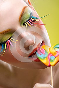 Colorful twisted lollipop and colorful extreme fashion makeup