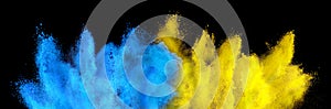 Colorful ukrainan flag yellow blue color holi paint powder explosion isolated black background. russia ukraine conflict war