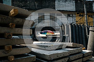 Colorful umbrella amidst concrete construction material in Bangkok, Thailand