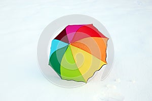 Colorful umbrella in fresh snow