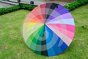Colorful umbrella on grass in garden