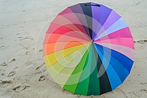 Colorful umbrella on sandy beach