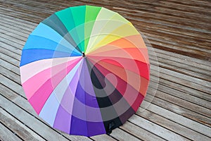 Colorful umbrella on wood floor